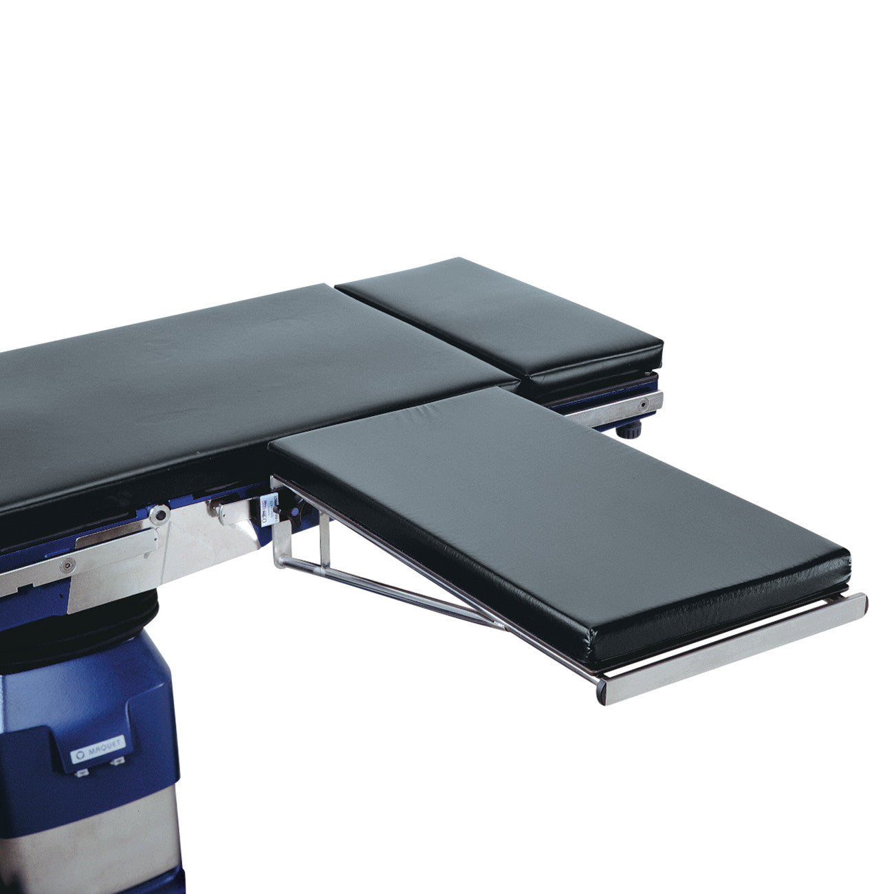 The Allen Basic Carpa Hand Table is attached to an operating table, featuring a padded surface and a metal support structure.