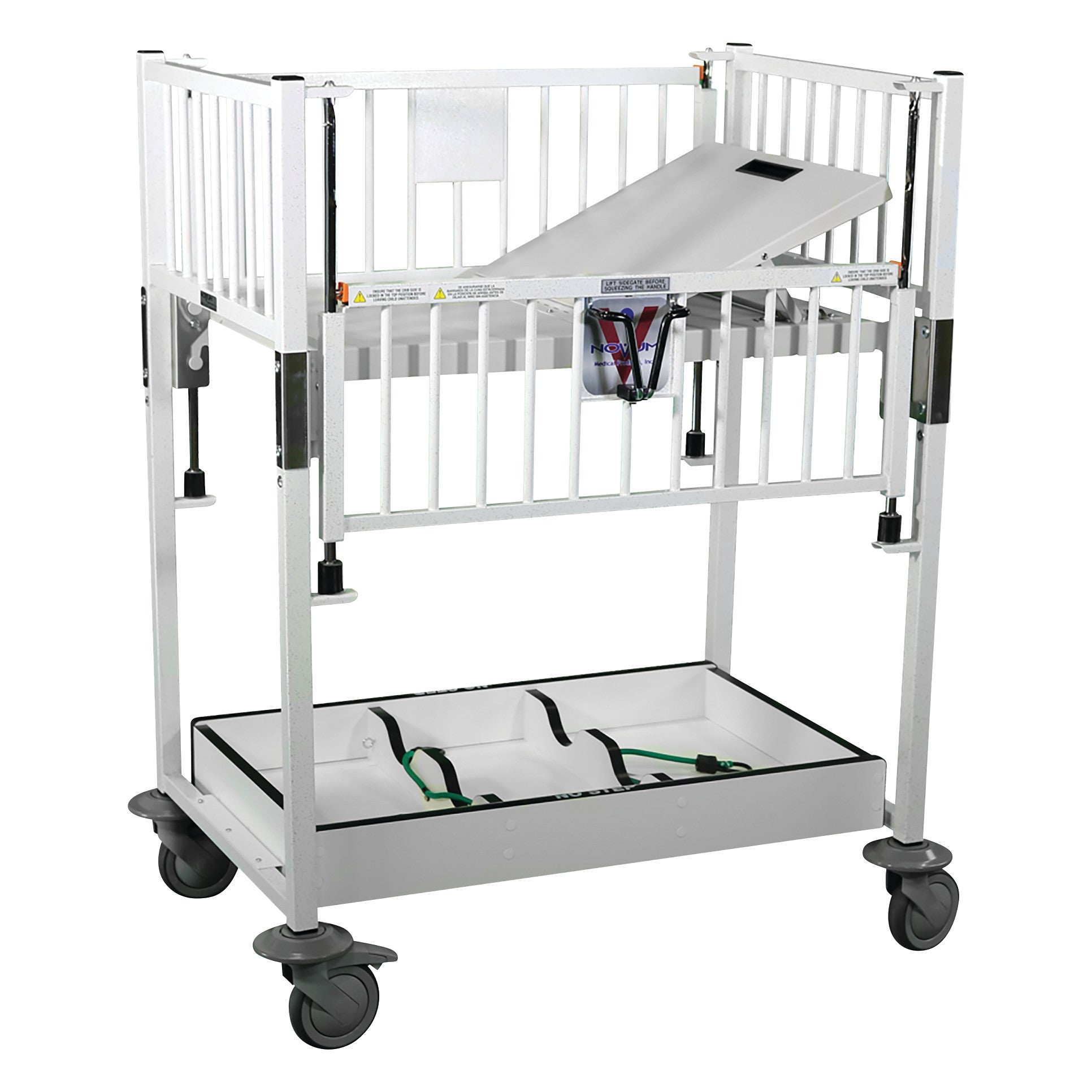 Novum Medical Neonatal Cribette with adjustable white metal frame, side rails, and lockable wheels, featuring an incline board.
