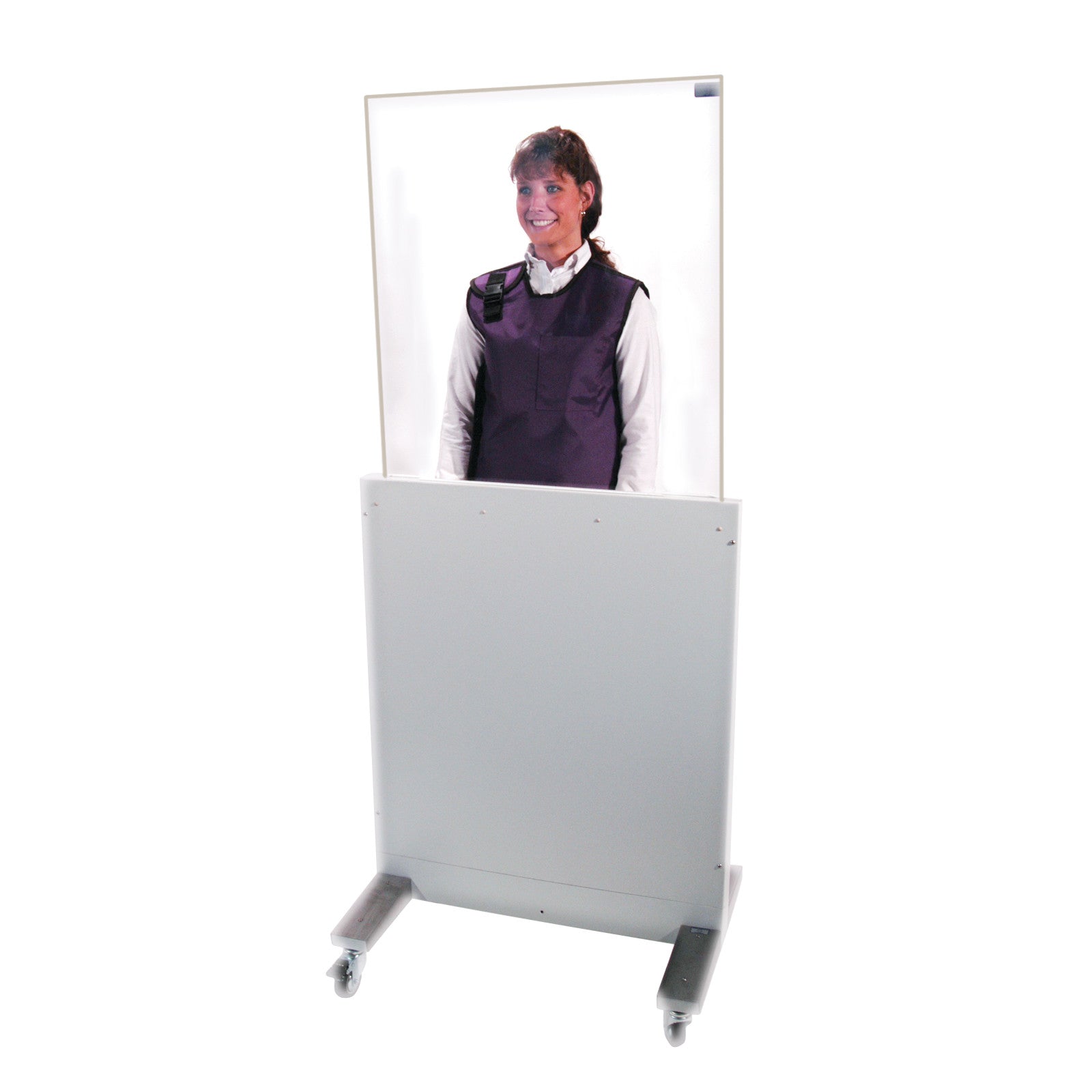A person stands behind a movable, transparent RayShield Adjust-A-Height Barrier on wheels, wearing a protective vest.