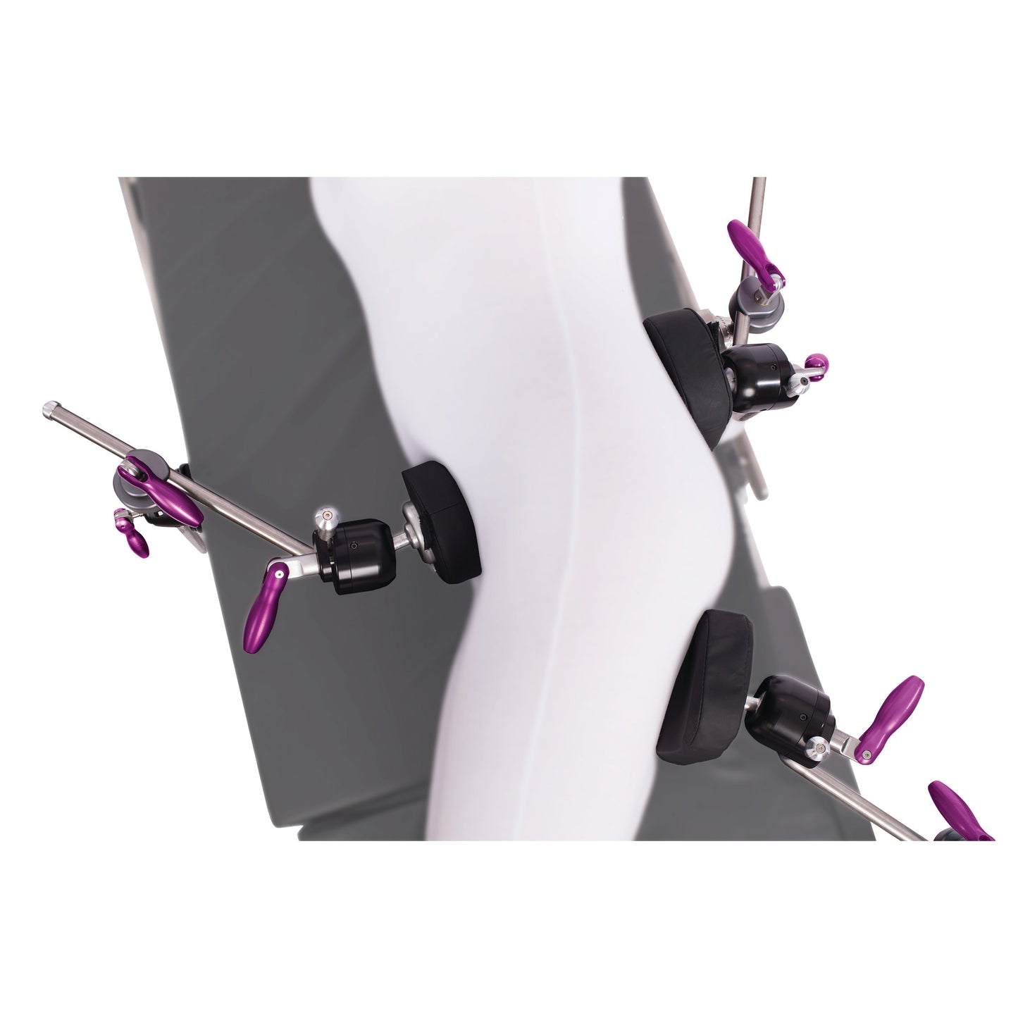The KYRA Lateral Positioning Set secures a mannequin leg with multiple padded clamps and purple levers for medical positioning.