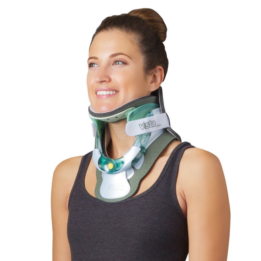 A woman wearing an Aspen Vista TX Cervical Collar Set, smiling and looking upward while dressed in a dark sleeveless top.