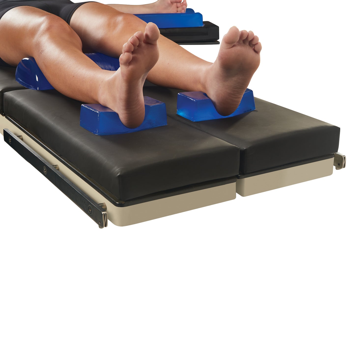 Person's legs on a hospital bed with AliMed AliBlue Gel Heel Cup Positioners supporting the heels.