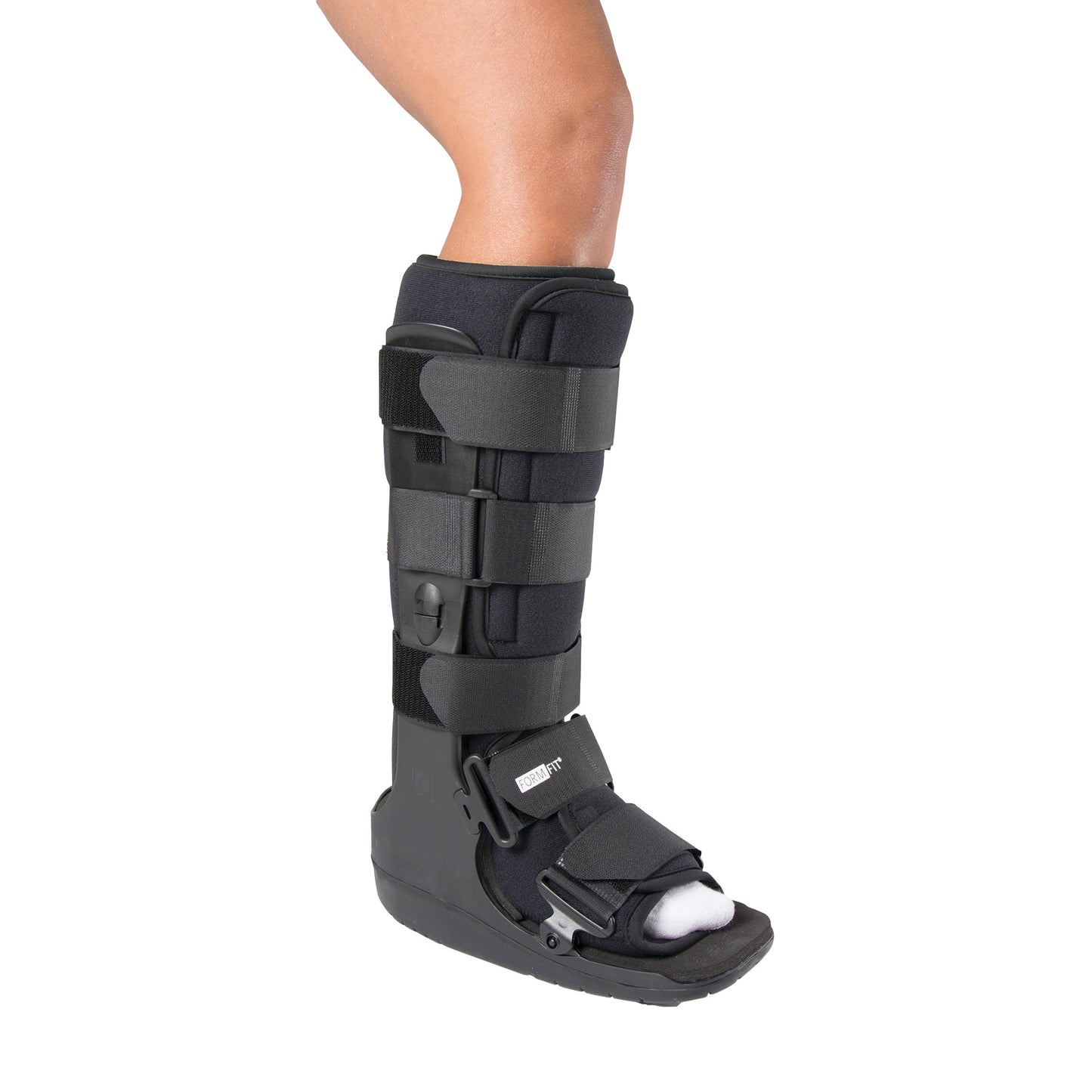 A person wearing an �ssur Formfit High-Top Walker boot with multiple straps for support on an injured foot and lower leg.