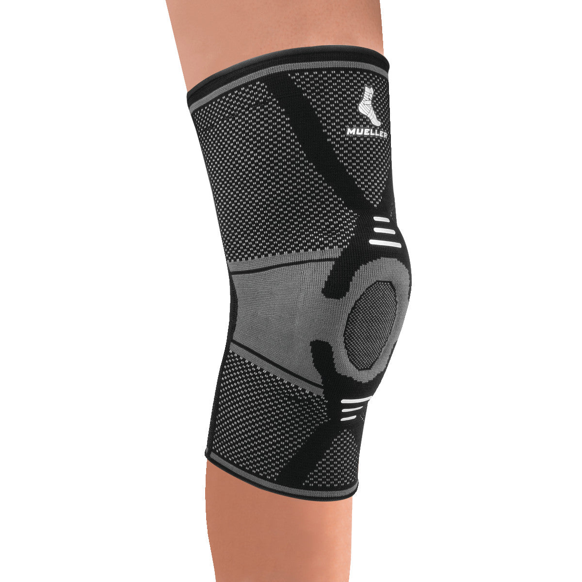 A person wears a Mueller Omniforce Knee Support, a black and gray compression sleeve with a reinforced patella area.