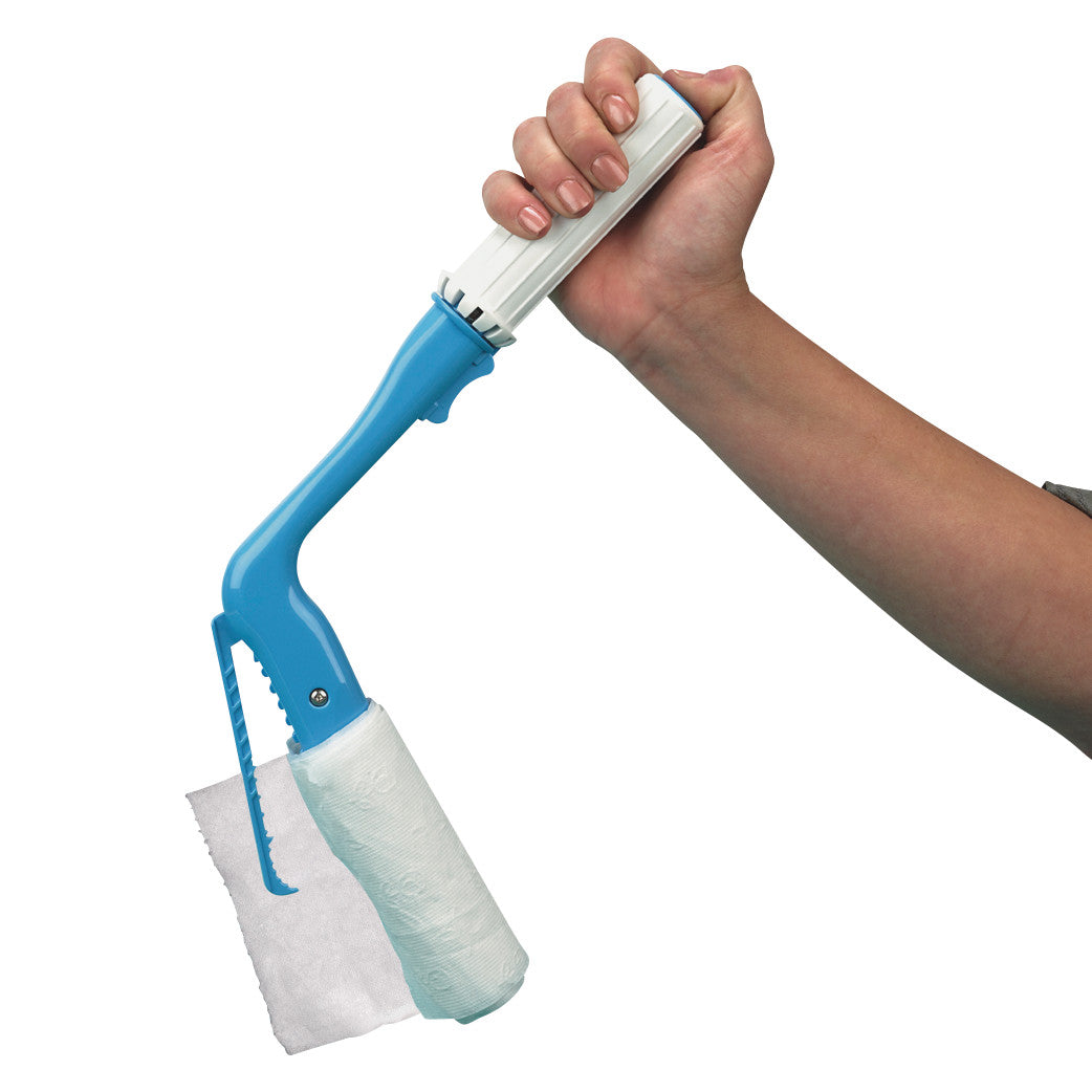 A hand holds a Self Wipe Toileting Hygiene Aid with a blue handle and a mounted roll of tissue for personal hygiene assistance.