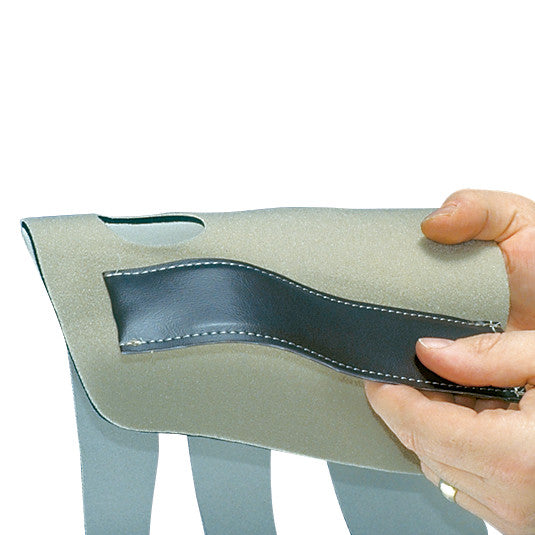 A hand holds the AliMed Conventional Neoprene Universal Wrist Support, showcasing its soft fabric and adjustable strap with stitched edges.