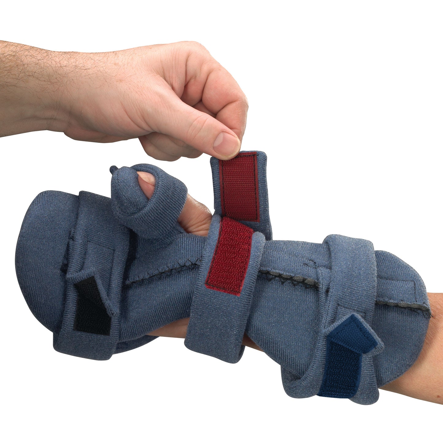 A person's hand adjusts the OCSI SoftPro Functional Resting WHFO brace, which has blue padding and colored straps.