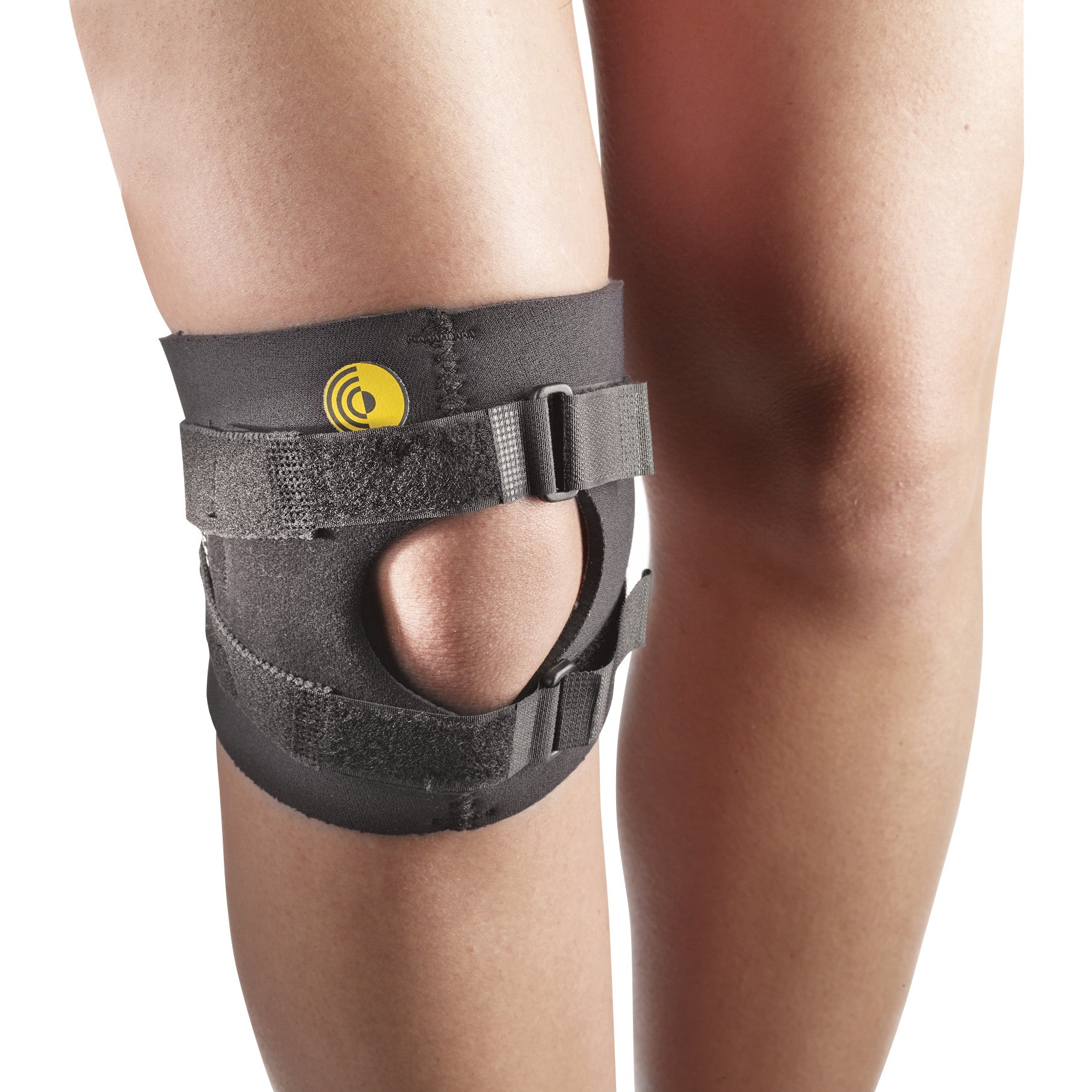 A person wears a 6"L Knee-O-Trakker Knee Brace with open patella design and adjustable straps for support and stabilization.