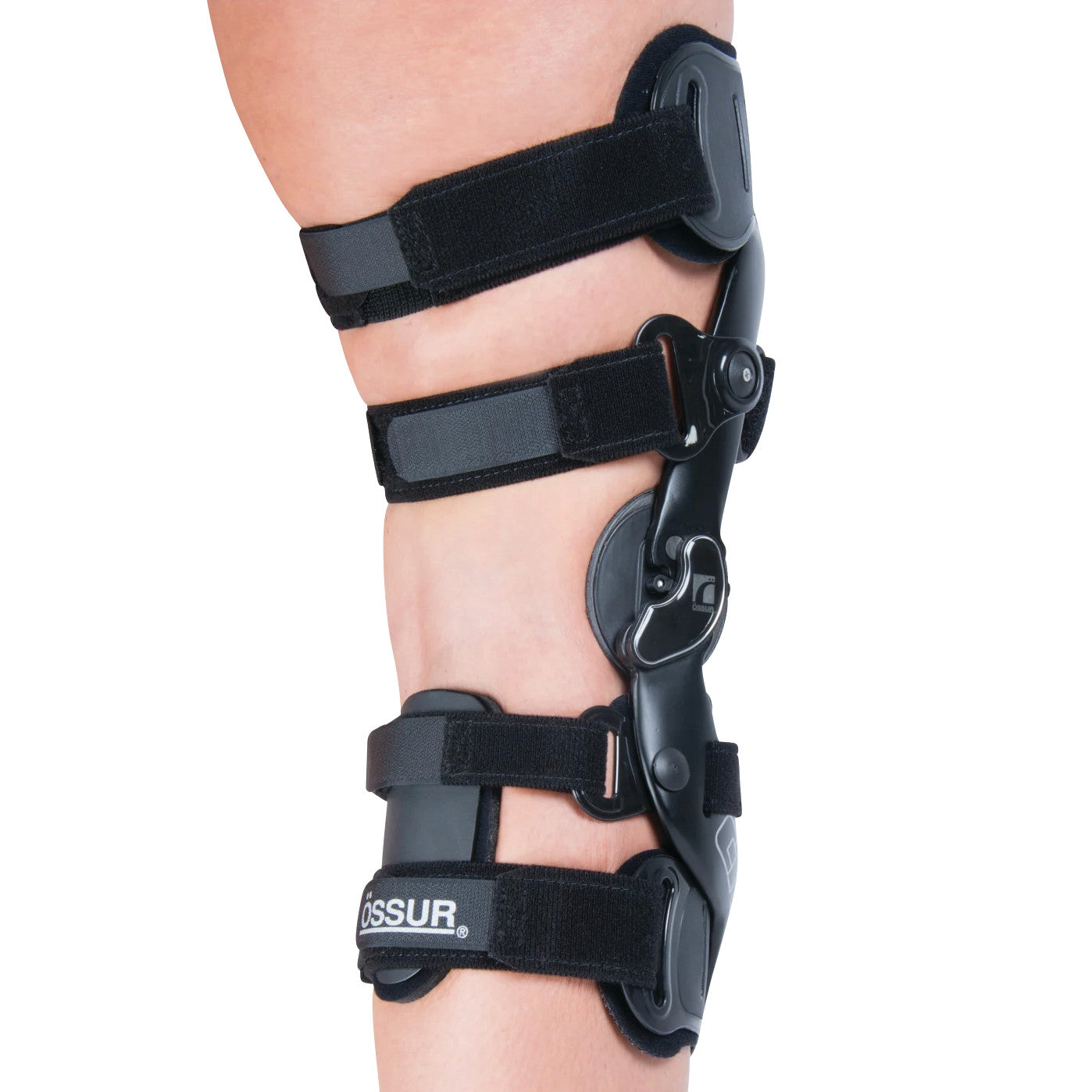 A person wears an ssur CTi OTS Knee Brace. It has a black frame with adjustable straps for support and stability.