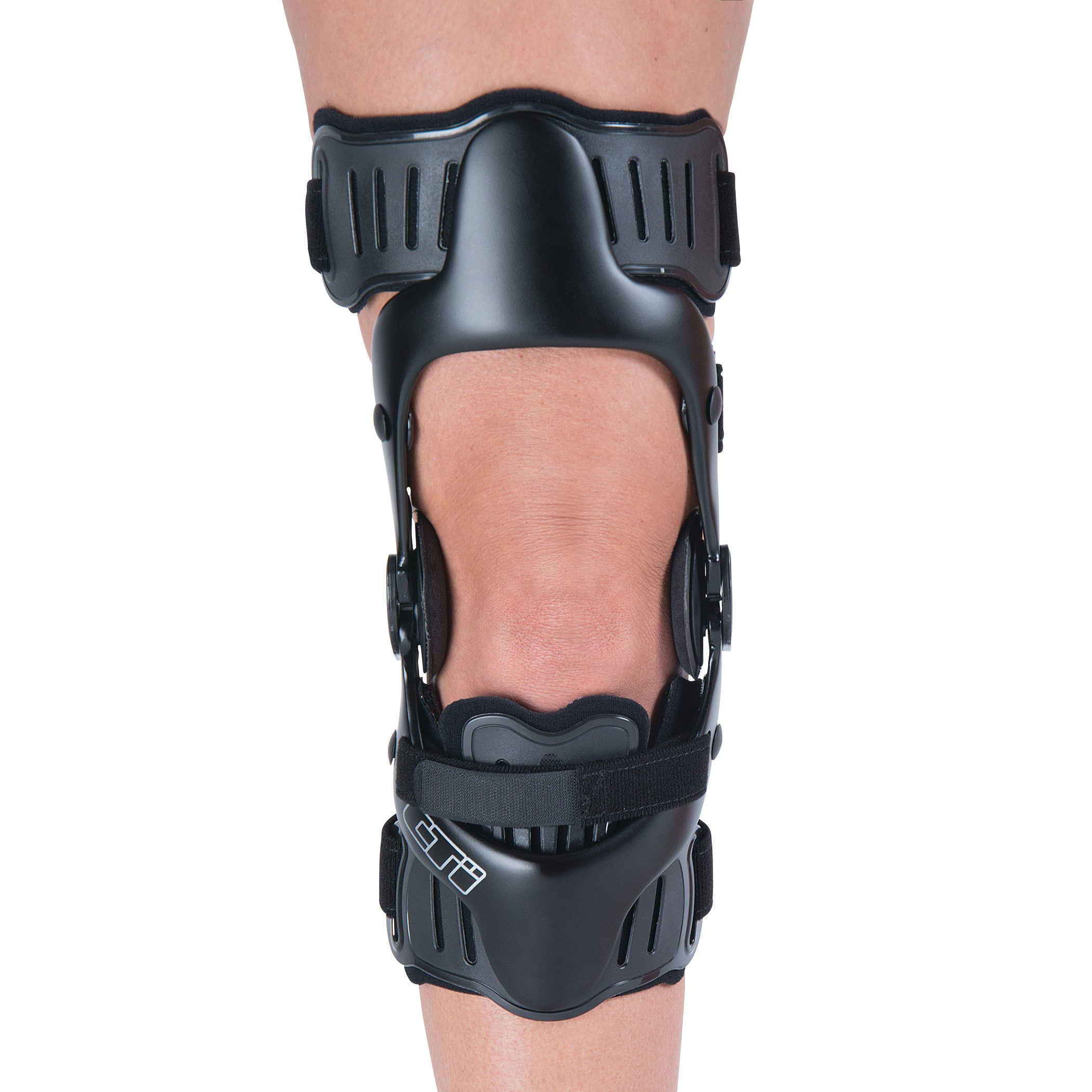 A person wears an Ossur CTi OTS Knee Brace, featuring black plastic supports and adjustable straps above and below the knee.