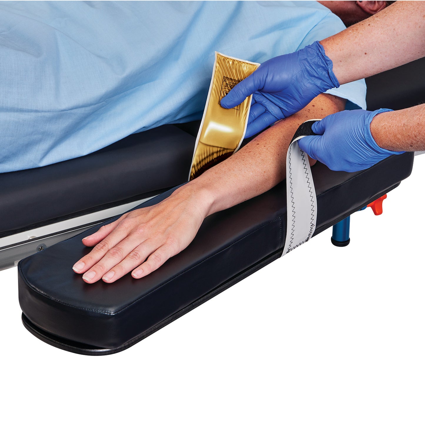 A person uses the Action Gel Arm/Hand Stabilizer Strap to securely position an arm on a cushioned platform.
