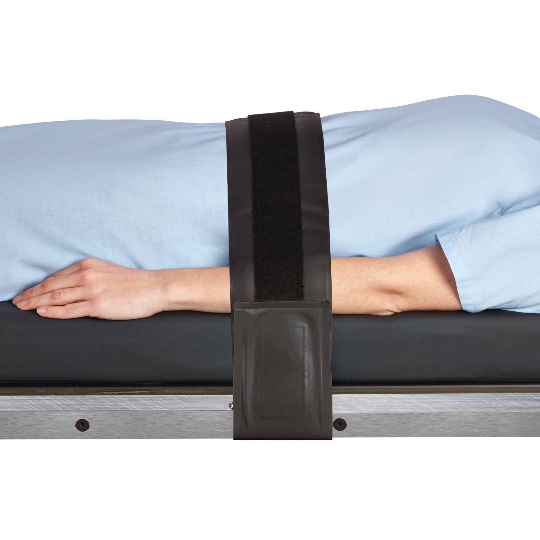 A person wearing a light blue garment lies on a table, with arms secured by an AliMed AliGel Surgical Table Strap across the torso.