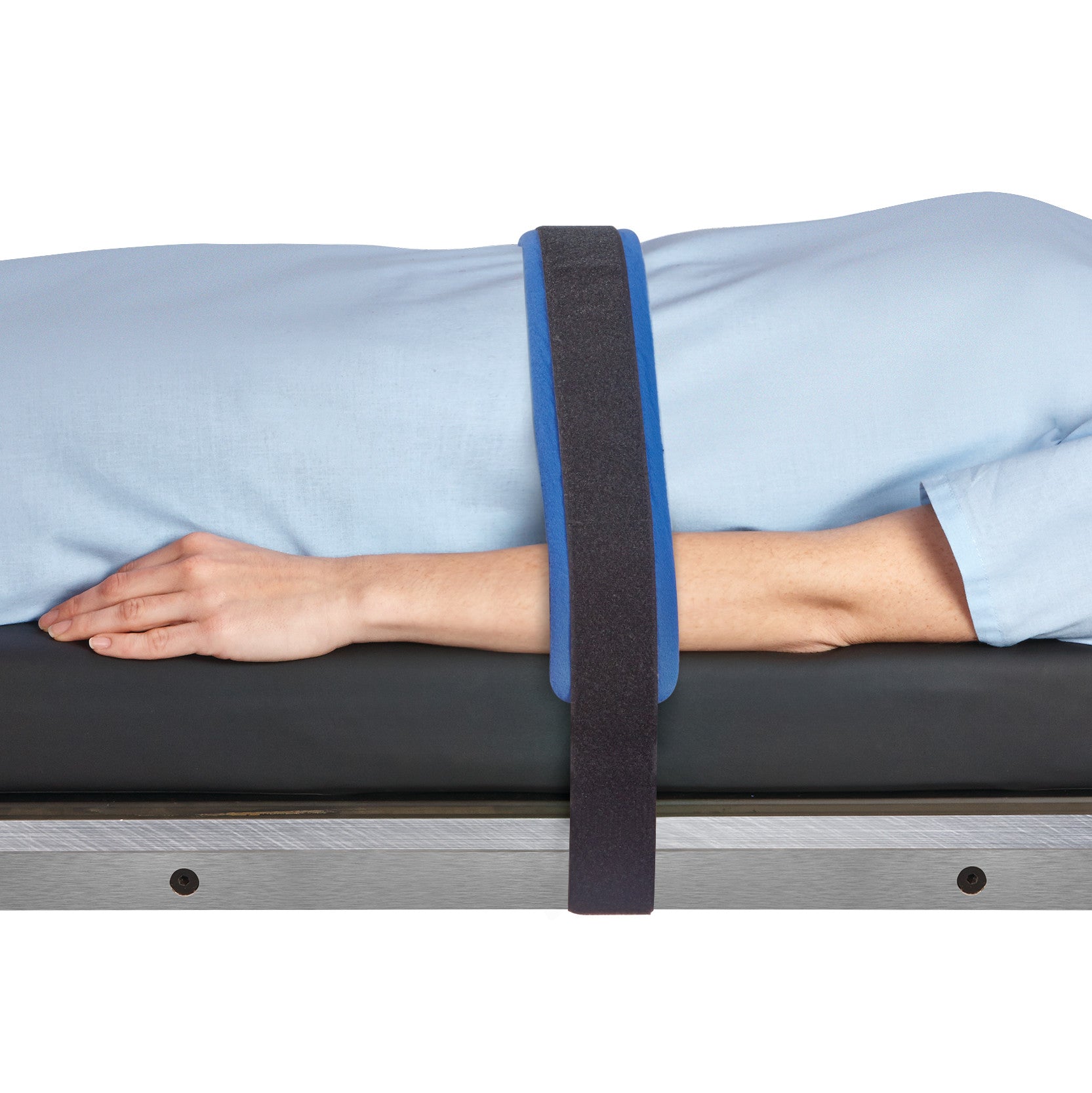 A person on a table secured with an AliMed Disposable Surgical Strap, which is black with blue edges.
