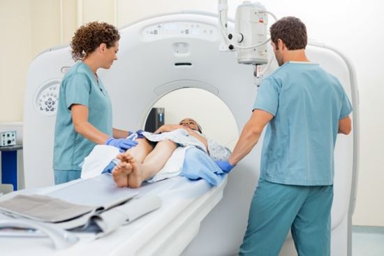 nurses putting patient in CT scan