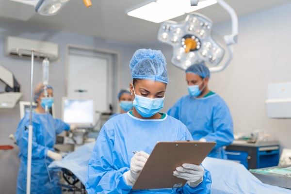 nurse writing on clipboard in operating room