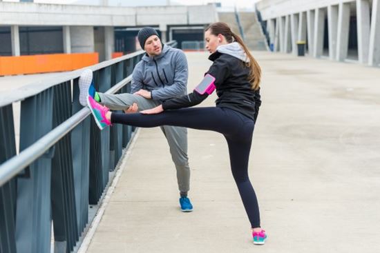 two people stretching before their run