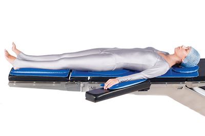patient lying on operating table with patient positioners