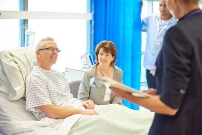nurse talking with patient in hospital room