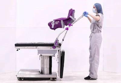 nurse setting up lithotomy stirrups