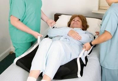 nurses transfering patient using alimed booster