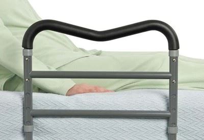 patient lying in bed with bed safety rail