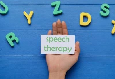 iperson holding paper that says speech therapy