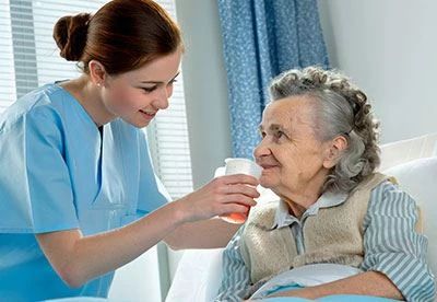 nurse helping patient drink