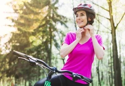 woman putting on helmet