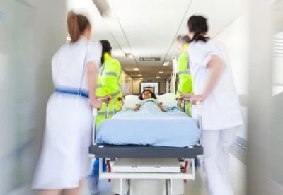nurses rushing through hospital with stretched