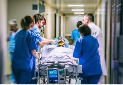nurses rushing stretcher through hospital