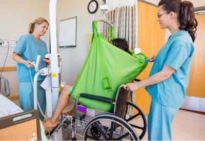 nurses using patient lift to transfer patient
