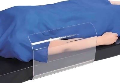 patient on operating table with toboggan arm guard