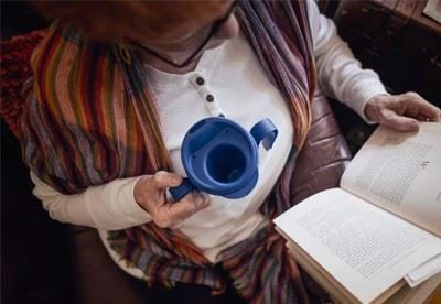 woman holding provale cup while reading