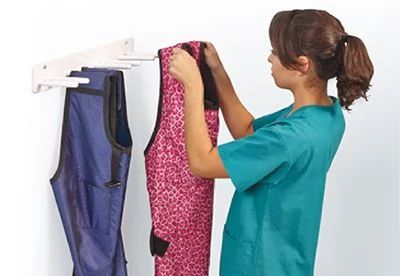 woman hanging aprons on apron rack