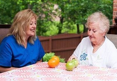 nurse sitting with patient outside