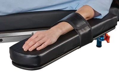 patient on operating table with arm on armboard with armboard strap