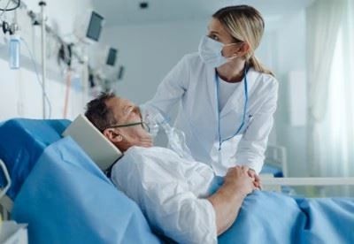 nurse with patient in hospital room