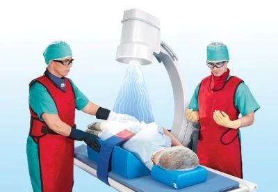 patient on table with raidaition rays and nurses positioning patient