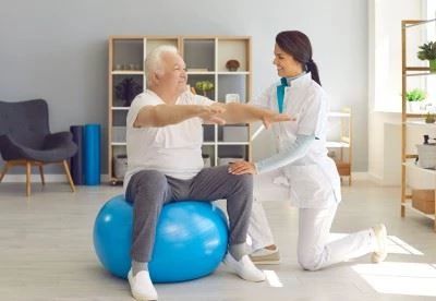 person doing therapeutic exercise with exercise ball