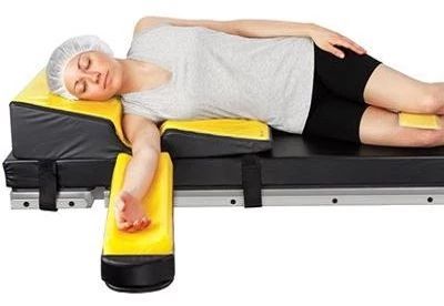 patient lying on operating table with patient positioners