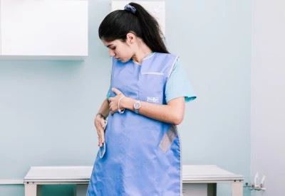 woman putting on radiation apron