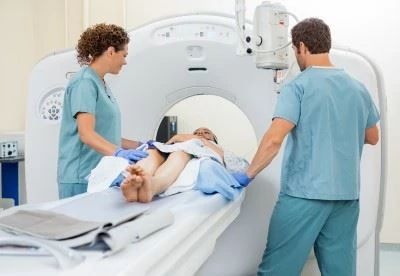 nurses putting patient in ct scan