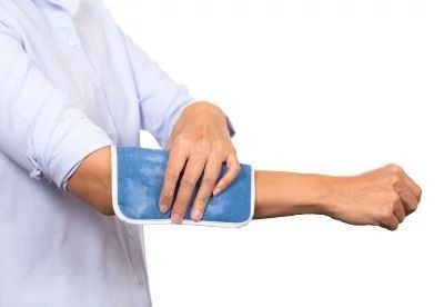 person using cold pack on arm