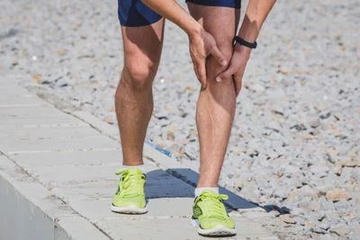 man holding his knee after walking