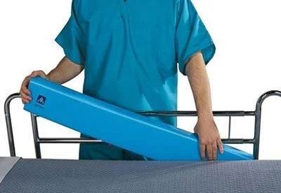 nurse putting bed bolster in side of bed