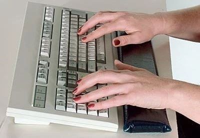 person typing on keyboard