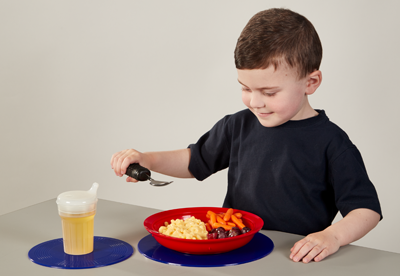 child using spoon to eat