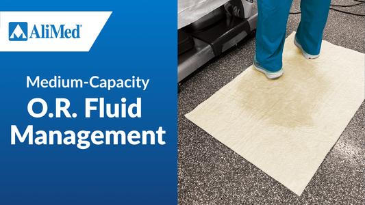 Operating room with person in scrubs standing on absorbent mat.  Text reads "Medium-Capacity O.R. Fluid Management"