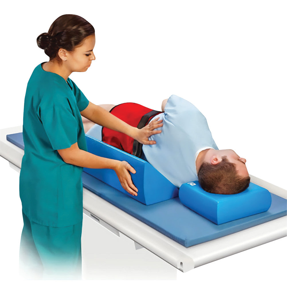 nurse putting invisicoat patient positioner under patients back on imaging table