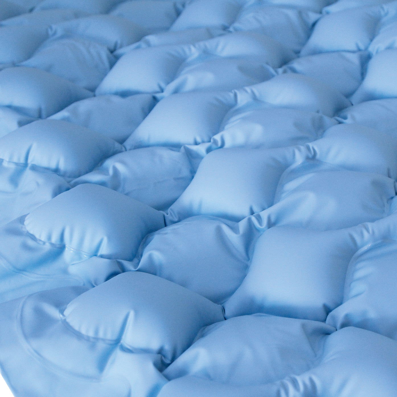 Close-up of a blue Replacement Bubble Pad for Protekt Aire 1500 Alternating Pressure Overlay System with a textured surface.